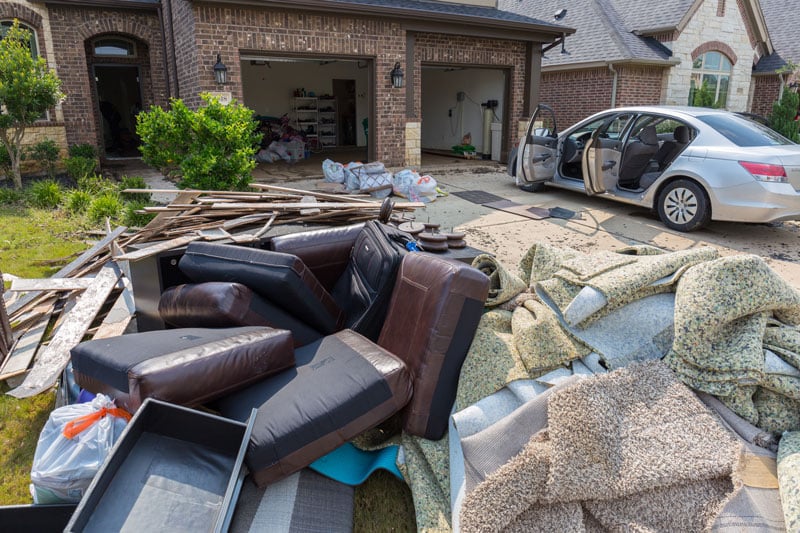 Flood damage & disaster cleanup - debris outside home