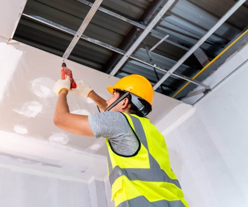 Restoration image showing new drywall being installed in the ceiling