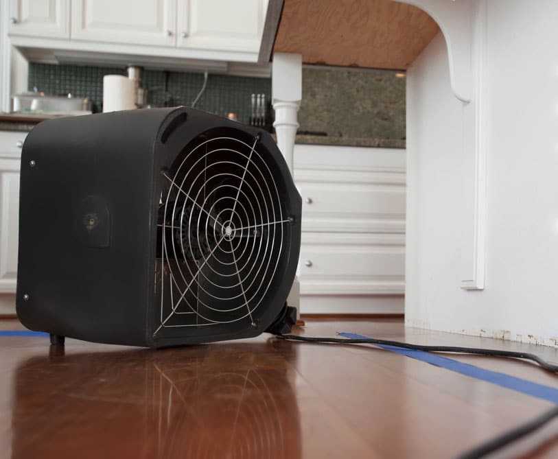 Flood cleanup photo of water dryer on wood floor