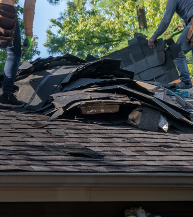 Storm damage on roof - two professional starting cleanup process