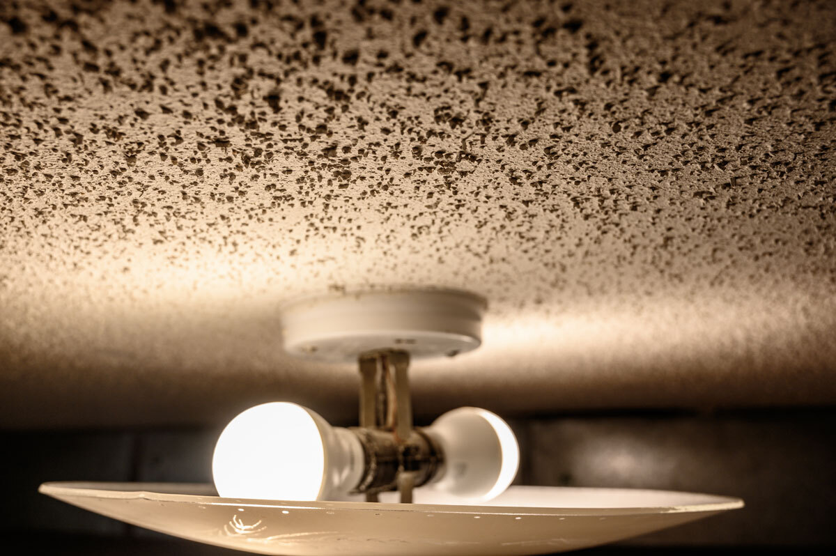 Popcorn ceiling with light bulb and fixture