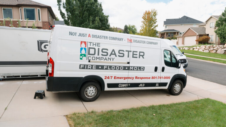 The Disaster Company van parked outside a Utah home on a restoration job